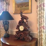 decorative-mantle-deer-clock-and-demilune-pair-of-lamps